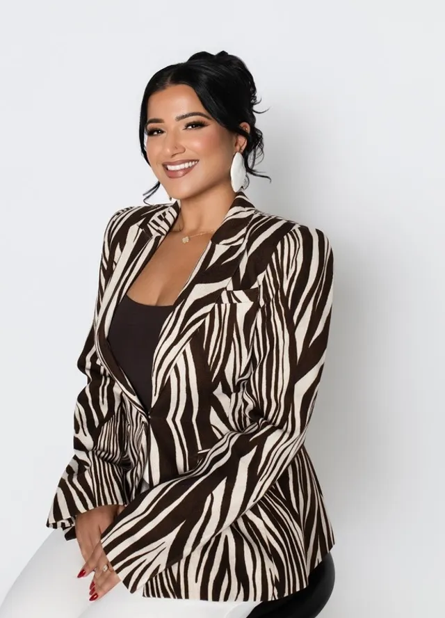 Saloni Singh, Esq., founder of Singh Law HQ, seated in her Riverside studio portrait
